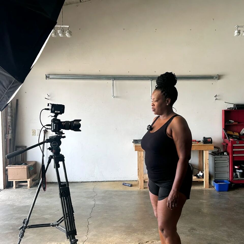 Instructor filming a dance workout in a garage studio