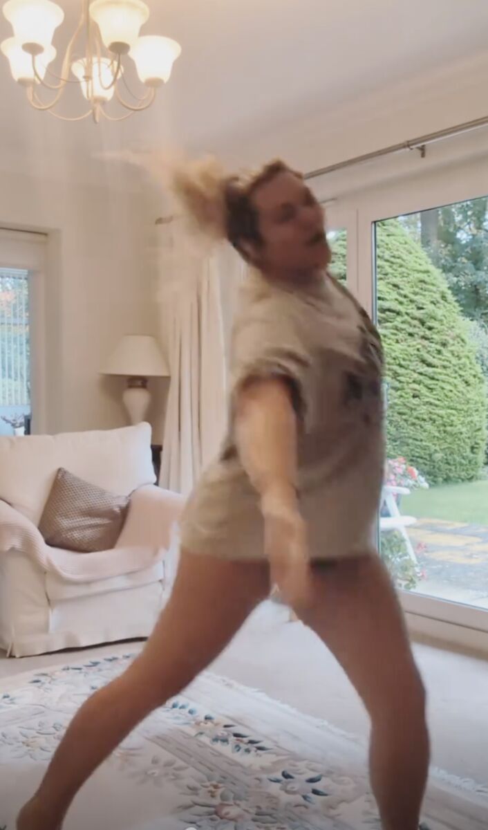 Woman dancing barefoot in her living room
